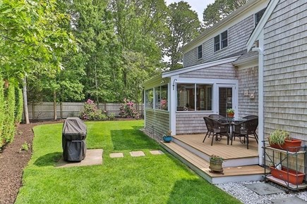 Harwich Cape Cod vacation rental - Backyard with deck and grill