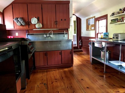 Brewster Cape Cod vacation rental - Industrial kitchen with original wide floorboards.