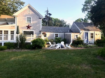 Brewster Cape Cod vacation rental - Sunroom opens onto large porch with grill, firepit and lawn.