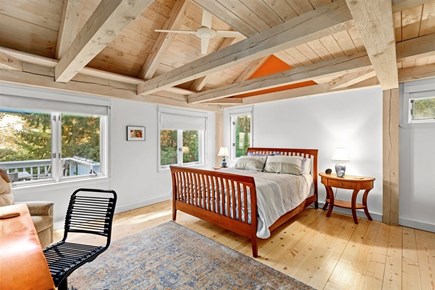 Mashpee Cape Cod vacation rental - Primary bedroom with a queen bed and views of the backyard