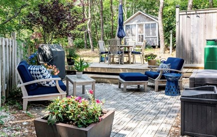 Truro Cape Cod vacation rental - Patio area with seating and dining set and grill