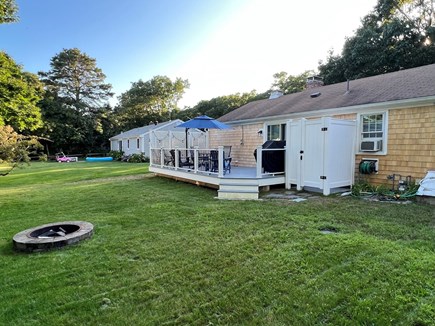 Yarmouth Cape Cod vacation rental - Backyard with new deck, outdoor shower, grill and fire pit