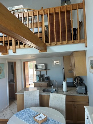 Chatham Cape Cod vacation rental - Dining area next to kitchen high ceiling with loft bedroom