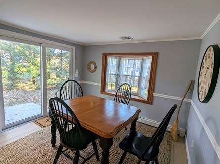 Dennis Cape Cod vacation rental - Dining table and sliders to patio and yard