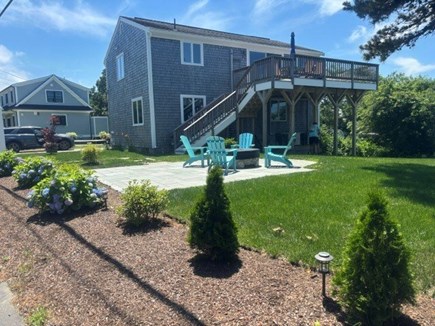 Eastham Cape Cod vacation rental - Yard with deck with view of bay and firepit!