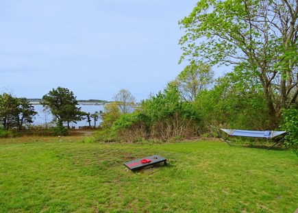 Wellfleet, Pine Point Cape Cod vacation rental - View from the deck towards beach & water, showing games & hammock