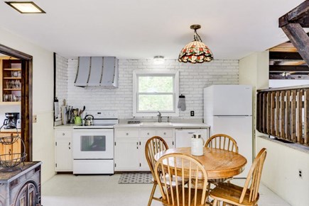 Harwich — on Long Pond Cape Cod vacation rental - Kitchen with full stove / oven, fridge, and breakfast table.