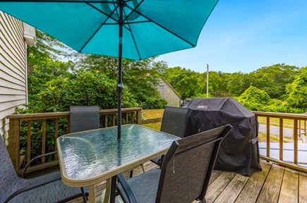 Harwich — on Long Pond Cape Cod vacation rental - Back porch with Weber grille, table, and 4 chairs.