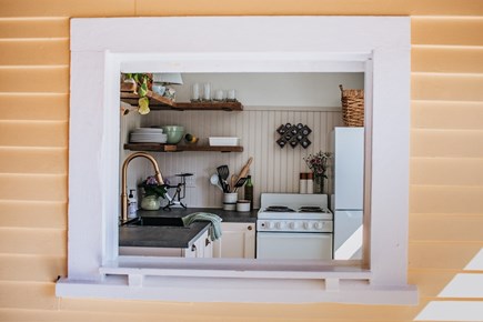 Dennis Village Cape Cod vacation rental - Antique casement window opens kitchen to the screened-in porch.