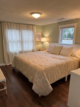 West Dennis Cape Cod vacation rental - Primary Bedroom - King bed, flatscreen tv and desk/vanity area
