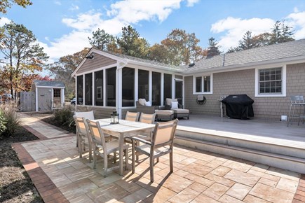 Eastham Cape Cod vacation rental - Back deck and patio with more seating, dining table and grill