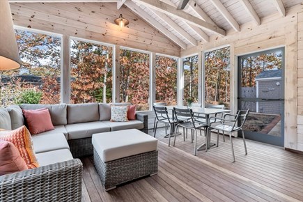 Eastham Cape Cod vacation rental - Screened in porch with seating, dining area and TV