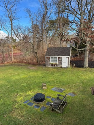 Harwich Cape Cod vacation rental - Backyard fire pit and cottage/office