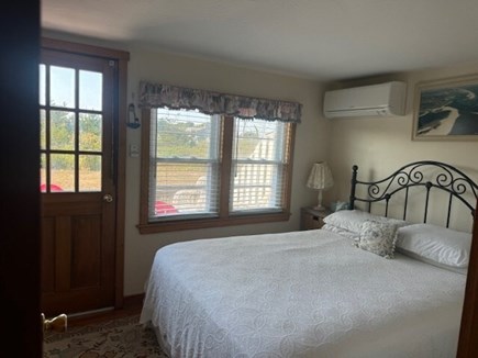 Chatham Oceanfront Condos Cape Cod vacation rental - Downstairs bedroom with queen bed, TV & A/C, leads to back patio.