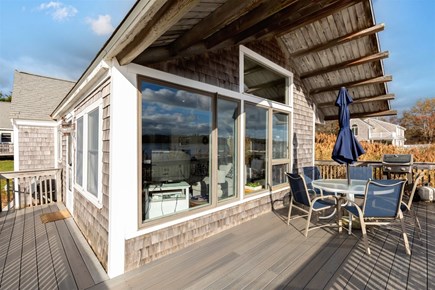 Eastham Cape Cod vacation rental - Back deck with dining table, umbrella, and grill for outdoor meal