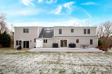 Eastham Cape Cod vacation rental - Deck with an outdoor dining table and grill for dining al fresco