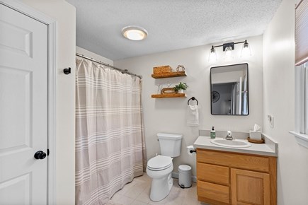 Eastham Cape Cod vacation rental - Primary ensuite with a tub / shower combo