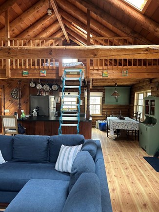 Harwich Cape Cod vacation rental - Living room/kitchen. Ladder to loft bedroom.