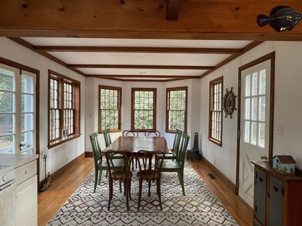 Harwich Cape Cod vacation rental - Eating area flooded with natural light & rhododendrons out back