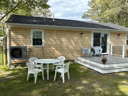 Falmouth Cape Cod vacation rental - Back of house with outdoor seating gas grill and fire pit.