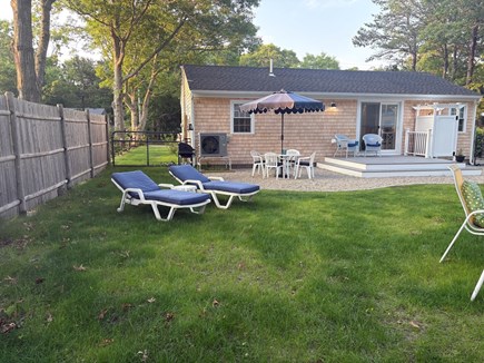 Falmouth Cape Cod vacation rental - Backyard with deck, gas grill, fire pit and outdoor shower.