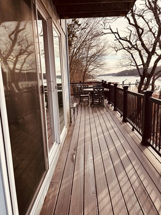 East Falmouth Cape Cod vacation rental - Large wrap around deck with seating for 8, 2 tables and umbrella