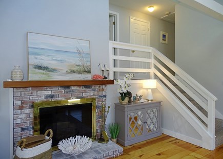 Eastham Cape Cod vacation rental - Charming fireplace - showing stairs to bedrooms 