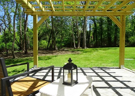 Eastham Cape Cod vacation rental - Patio with pergola, facing back yard