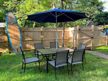 South Orleans Cape Cod vacation rental - Outdoor Dining Table and Umbrella in Fenced Yard