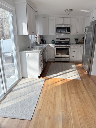 South Yarmouth Cape Cod vacation rental - View of kitchen and sliding glass door to the backyard