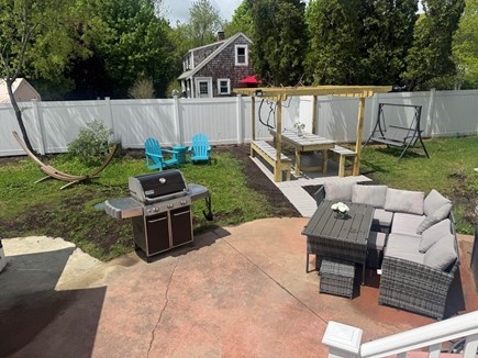 East Falmouth Cape Cod vacation rental - Backyard<br/>Pergola with large table, lots of seating space, grill