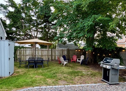 Barnstable Village Cape Cod vacation rental - Semi-fenced in backyard has outdoor shower, grill and dining area