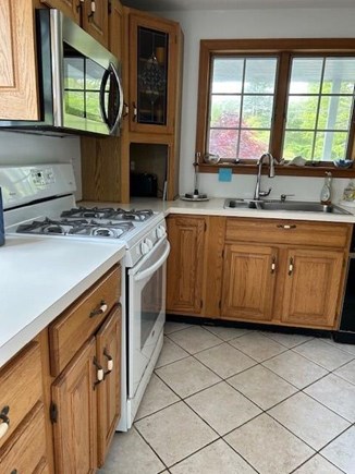 Popponesset Cape Cod vacation rental - Kitchen with gas stove, microwave, and more.