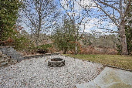 Centerville Cape Cod vacation rental - Fire pit in backyard