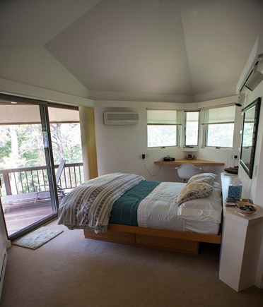 Wellfleet Cape Cod vacation rental - Primary bedroom with en suite bath, balcony, WI closet, and desk.