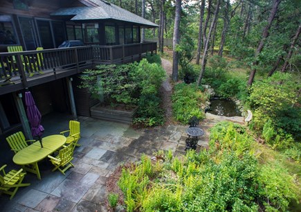 Wellfleet Cape Cod vacation rental - Back of house with frog pond, garden and bluestone patio.