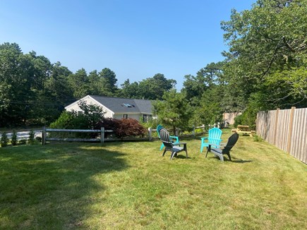 Harwich Cape Cod vacation rental - Upper play area, dining area with picnic table, and chairs