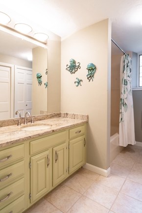 Brewster Cape Cod vacation rental - First floor bathroom with tub/shower and laundry