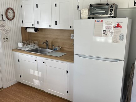 Dennis Port Cape Cod vacation rental - Kitchen sink, counter top, cabinets, refrigerator, toaster oven<br/>