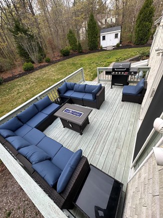 Mashpee Cape Cod vacation rental - Deck in the backyard with new fire pit,grill and furniture