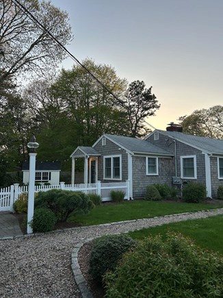 Harwichport Cape Cod vacation rental - Driveway view of side patio and outdoor living area