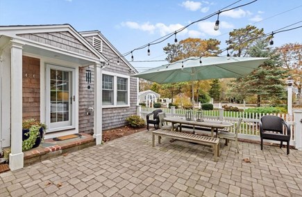 Harwich Cape Cod vacation rental - Outdoor living space with grill, patio, teak dining and loungers