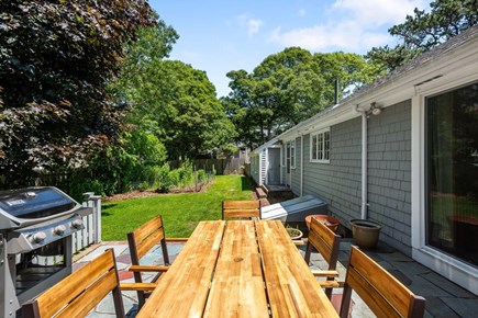 Yarmouth, Bass River - Blue Rock Landing Cape Cod vacation rental - Fenced backyard with new patio table/chairs and gas grill.