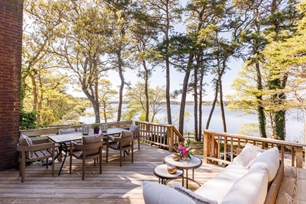 Harwich Cape Cod vacation rental - Waterfront deck with dining and seating.