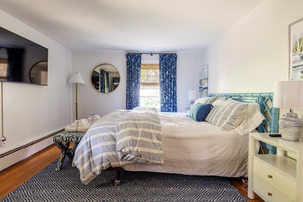 Harwich Cape Cod vacation rental - Primary King BR w/attached bath. 55” TV. Armoire for storage.