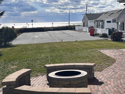 Dennisport Cape Cod vacation rental - Fire pit and patio overlooking the water