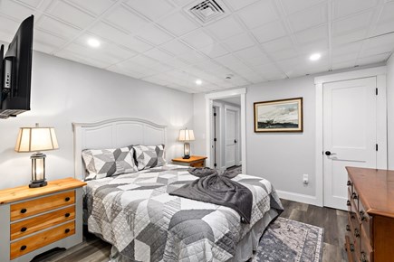 Orleans Cape Cod vacation rental - Lower level bedroom with a queen bed and a smart TV