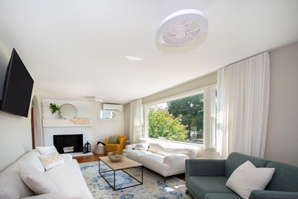 Hull MA vacation rental - This living space has 3 coaches and a twirling chair.