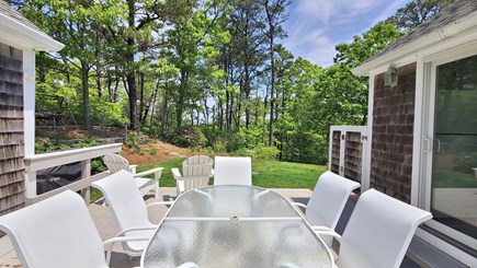 Truro Cape Cod vacation rental - Back deck with dining table and wooded views