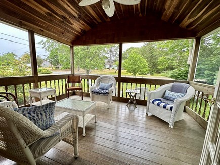 Dennisport Cape Cod vacation rental - Adirondacks out on the lawn and inside comfortable porch living